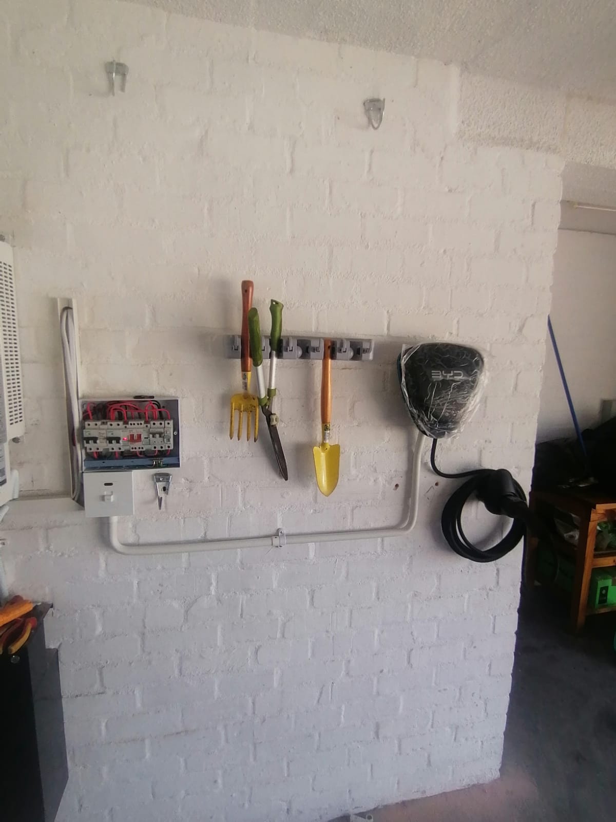 BYD home charger installed in a garage, with new DB board and conduit run